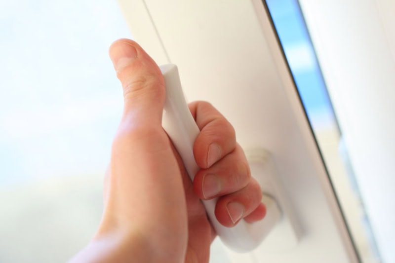 hand opening a window.